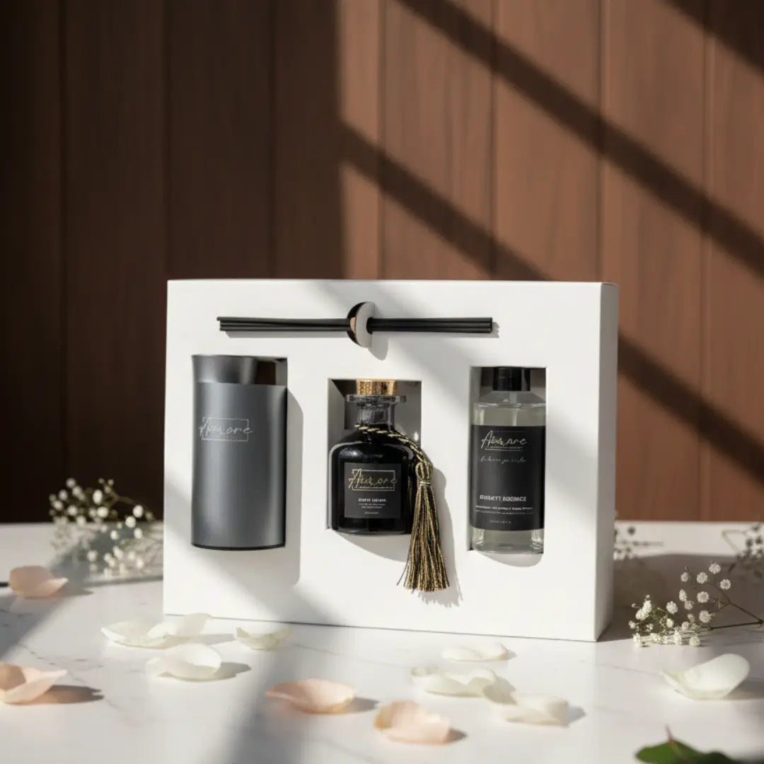 Gift set with black and gray bottles and a brush in a white box on a wooden surface with scattered petals.