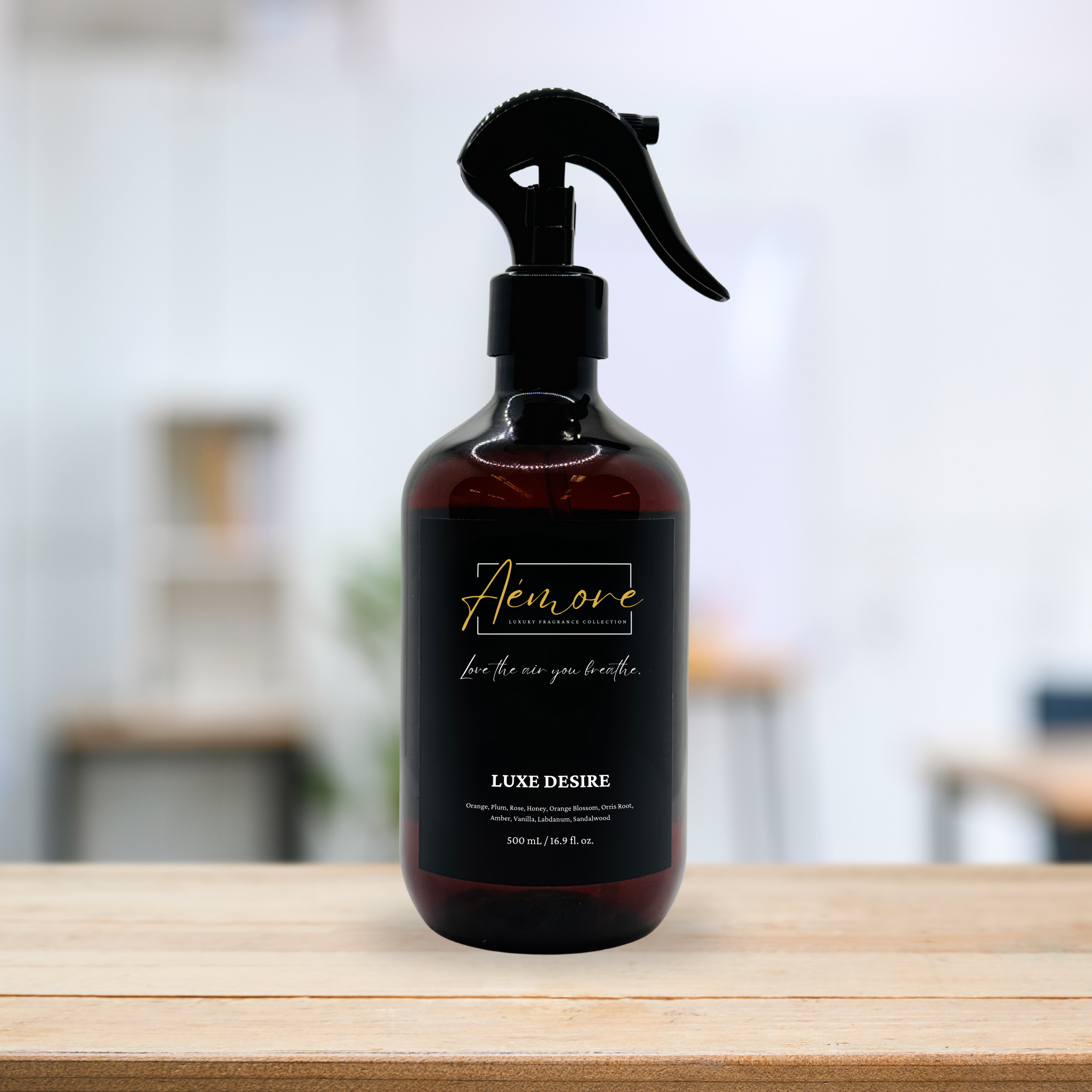 Brown spray bottle with black label on a wooden surface, blurred background